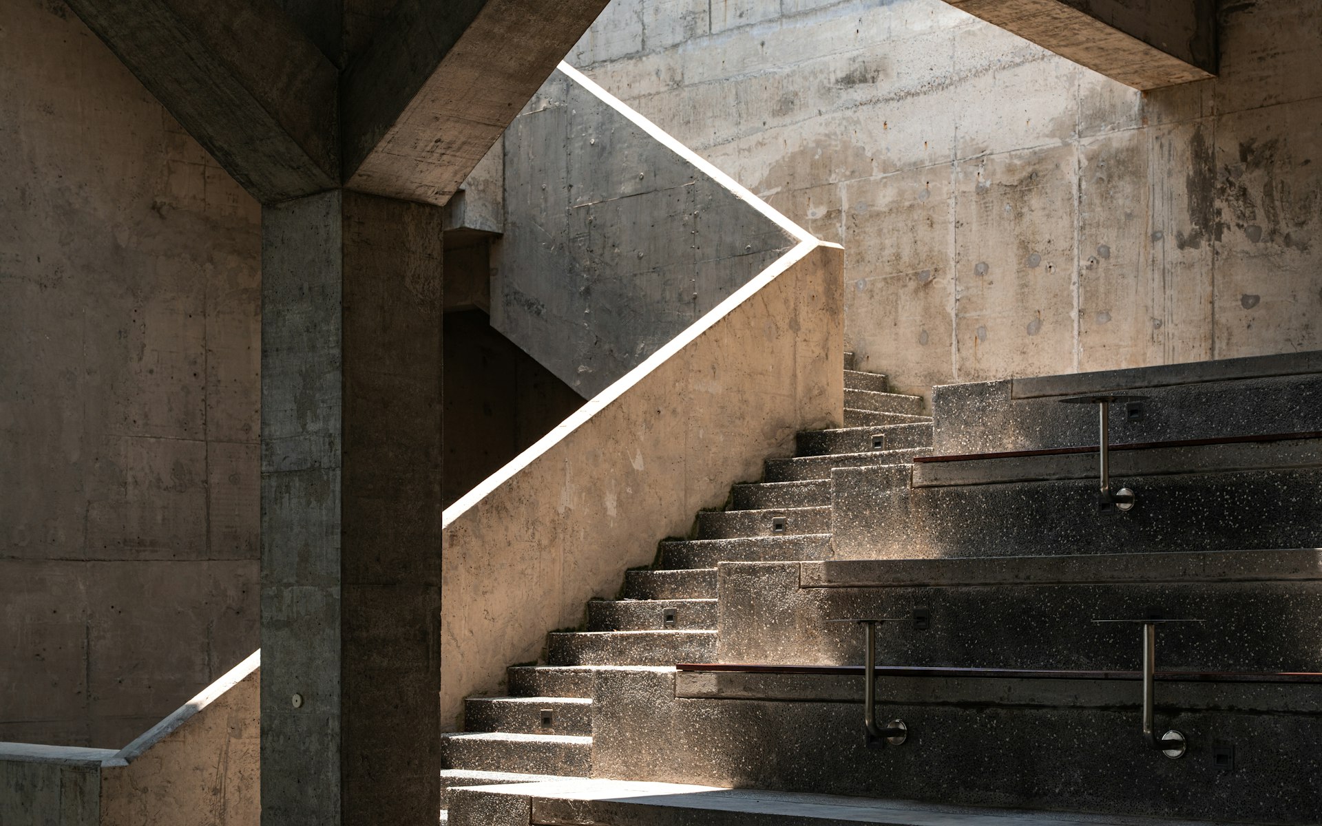 Sunlit concrete stairs with warm architectural light